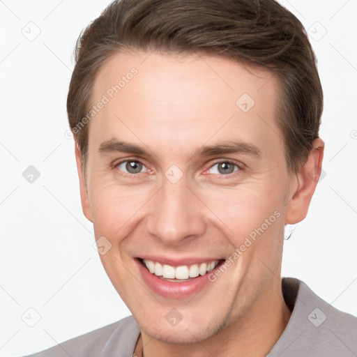 Joyful white young-adult male with short  brown hair and grey eyes