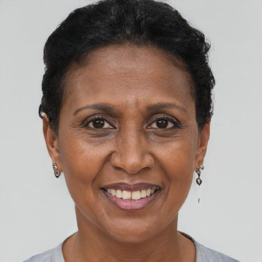 Joyful black adult female with short  brown hair and brown eyes