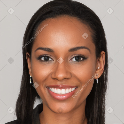 Joyful black young-adult female with long  black hair and brown eyes