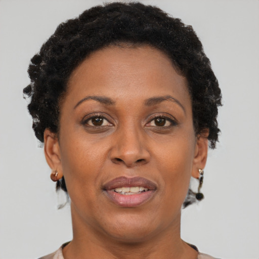 Joyful black adult female with short  brown hair and brown eyes