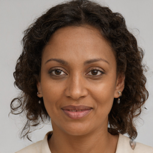Joyful black young-adult female with medium  brown hair and brown eyes