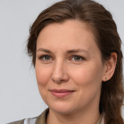 Joyful white adult female with medium  brown hair and brown eyes