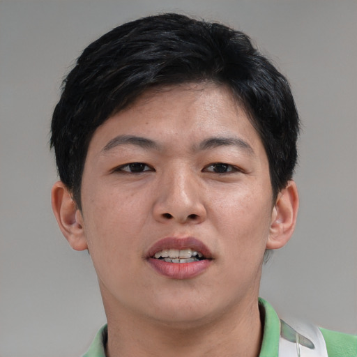 Joyful asian adult male with short  brown hair and brown eyes