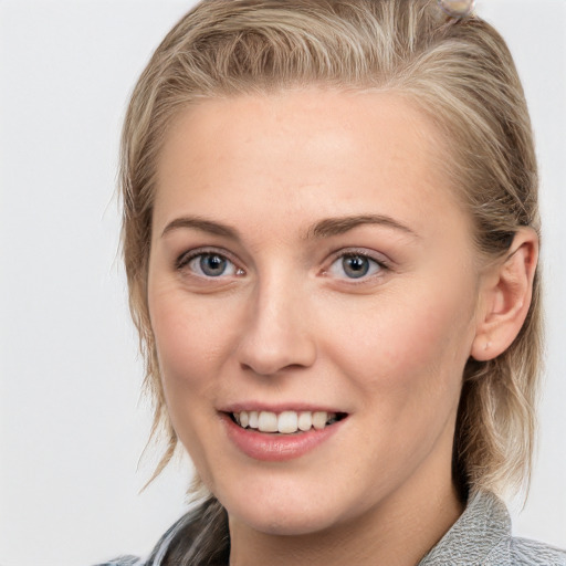 Joyful white young-adult female with medium  brown hair and blue eyes