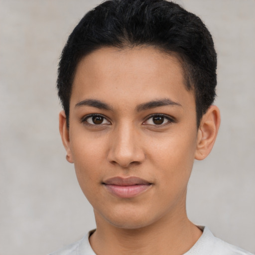 Joyful latino young-adult female with short  brown hair and brown eyes