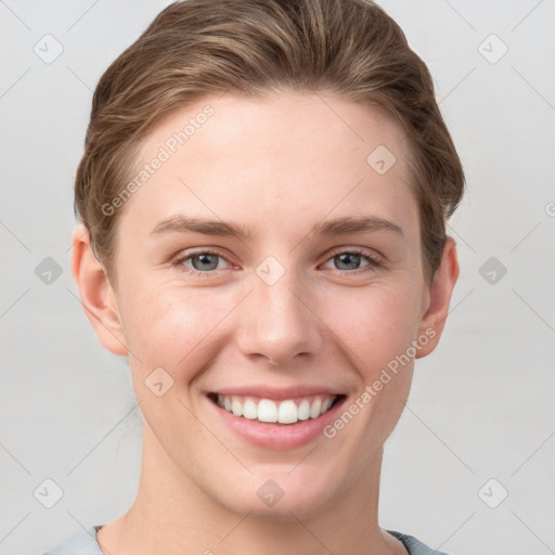 Joyful white young-adult female with short  brown hair and grey eyes