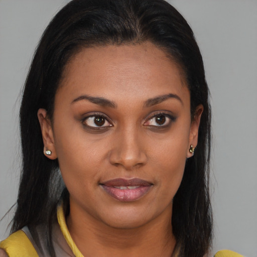 Joyful black young-adult female with medium  brown hair and brown eyes
