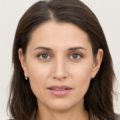 Joyful white young-adult female with long  brown hair and brown eyes