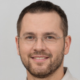 Joyful white adult male with short  brown hair and brown eyes