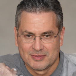 Joyful white middle-aged male with short  brown hair and brown eyes