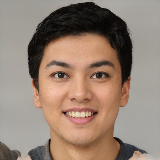 Joyful asian young-adult male with short  brown hair and brown eyes
