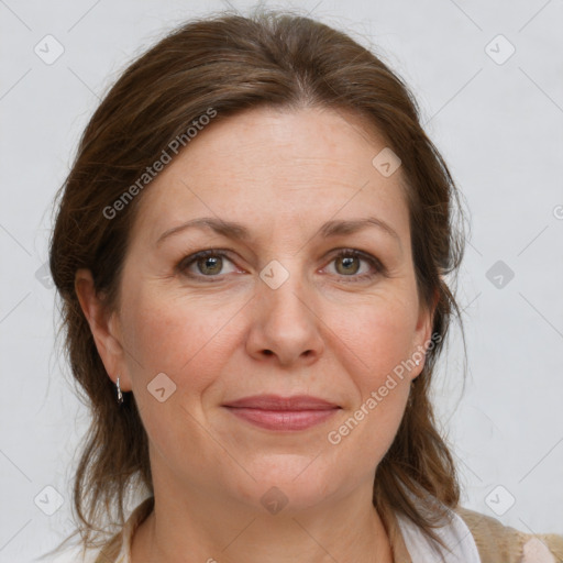 Joyful white adult female with medium  brown hair and blue eyes