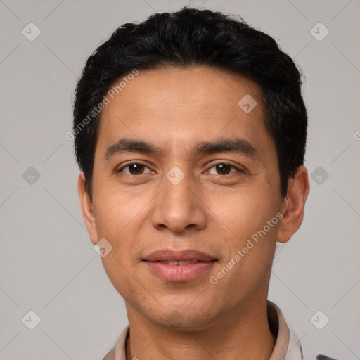 Joyful latino young-adult male with short  black hair and brown eyes