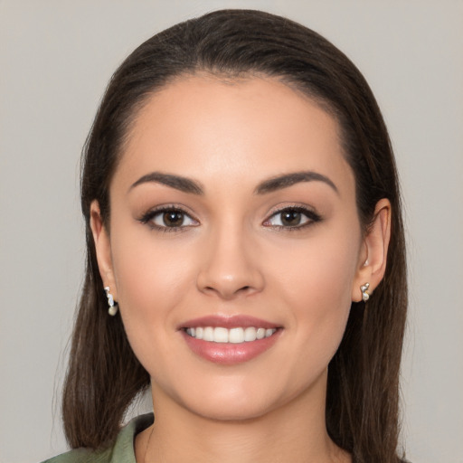 Joyful white young-adult female with long  brown hair and brown eyes