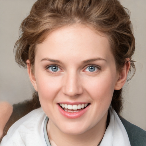 Joyful white young-adult female with medium  brown hair and blue eyes