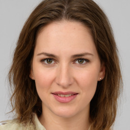 Joyful white young-adult female with long  brown hair and green eyes