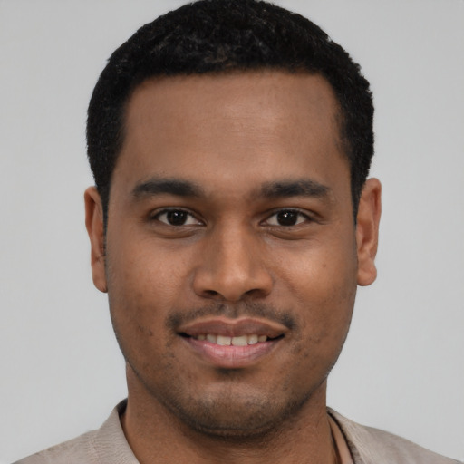 Joyful latino young-adult male with short  black hair and brown eyes