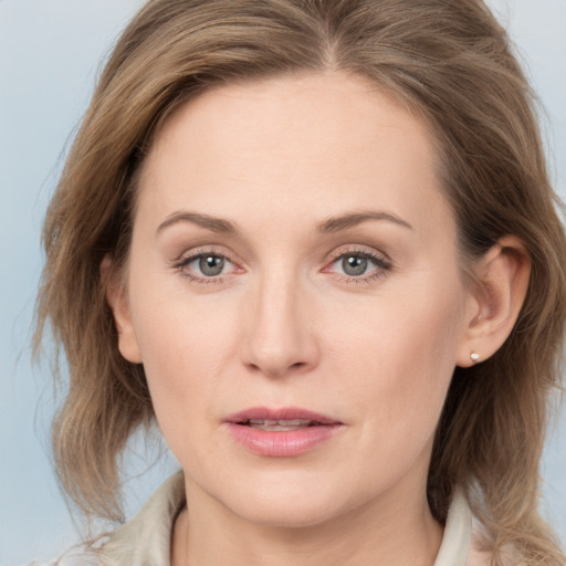 Joyful white young-adult female with medium  brown hair and blue eyes