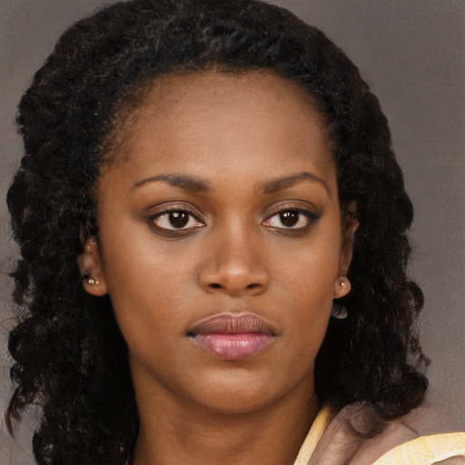 Neutral black young-adult female with long  brown hair and brown eyes