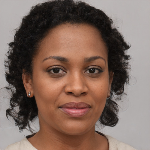 Joyful black young-adult female with medium  brown hair and brown eyes