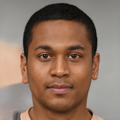 Joyful latino young-adult male with short  brown hair and brown eyes