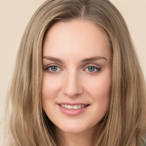 Joyful white young-adult female with long  brown hair and grey eyes