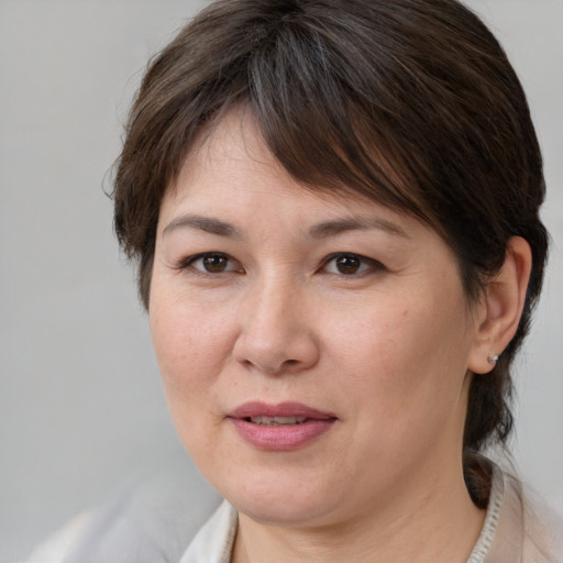 Joyful white adult female with medium  brown hair and brown eyes