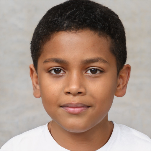 Joyful black child male with short  brown hair and brown eyes