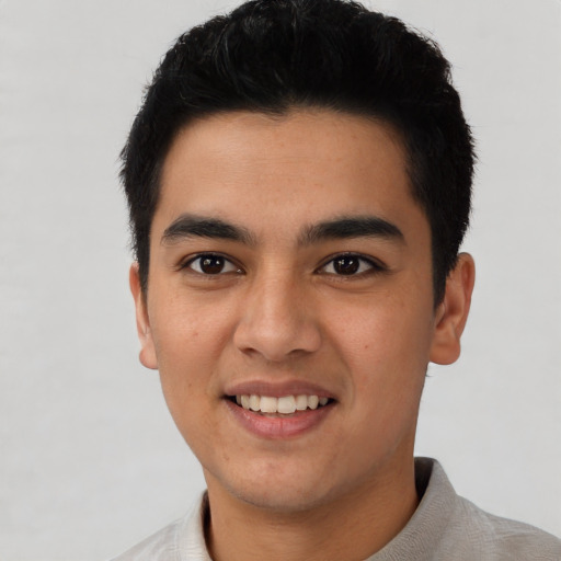 Joyful asian young-adult male with short  black hair and brown eyes