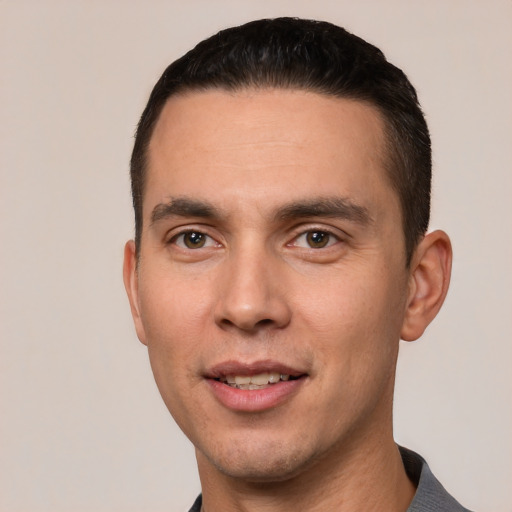 Joyful white young-adult male with short  black hair and brown eyes