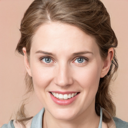 Joyful white young-adult female with medium  brown hair and blue eyes