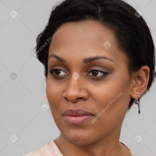 Joyful black young-adult female with short  brown hair and brown eyes