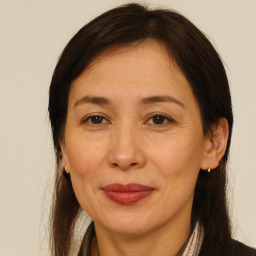 Joyful white adult female with long  brown hair and brown eyes