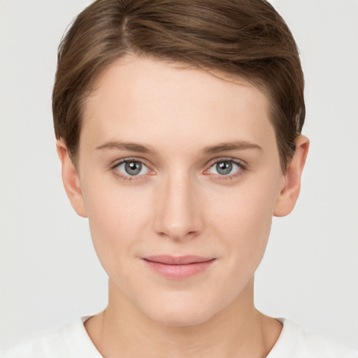 Joyful white young-adult female with short  brown hair and grey eyes