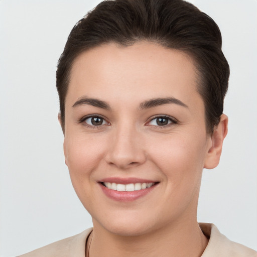 Joyful white young-adult female with short  brown hair and brown eyes