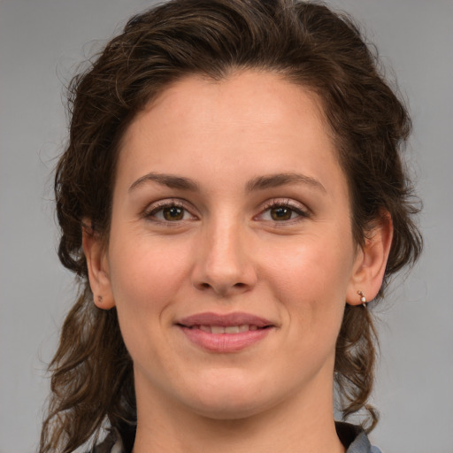 Joyful white young-adult female with medium  brown hair and green eyes