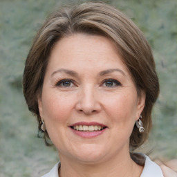 Joyful white adult female with medium  brown hair and grey eyes