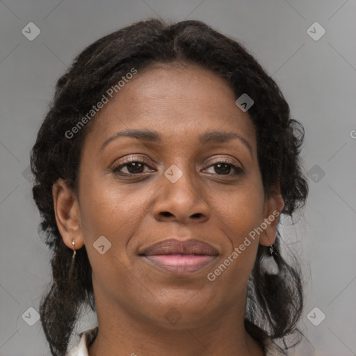 Joyful black adult female with medium  brown hair and brown eyes