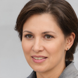 Joyful white adult female with medium  brown hair and brown eyes