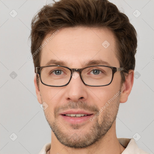 Joyful white adult male with short  brown hair and grey eyes