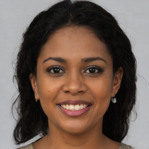 Joyful latino young-adult female with medium  brown hair and brown eyes