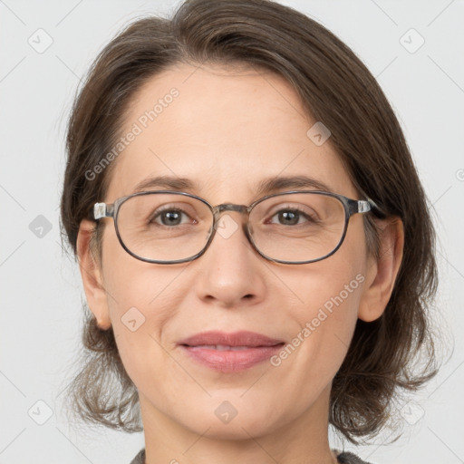 Joyful white adult female with medium  brown hair and grey eyes