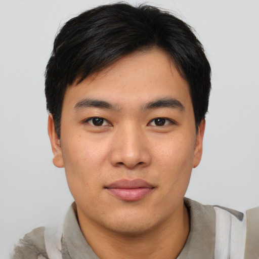 Joyful asian young-adult male with short  black hair and brown eyes