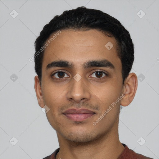 Joyful latino young-adult male with short  black hair and brown eyes