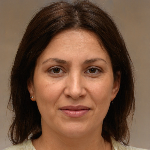 Joyful white adult female with medium  brown hair and brown eyes