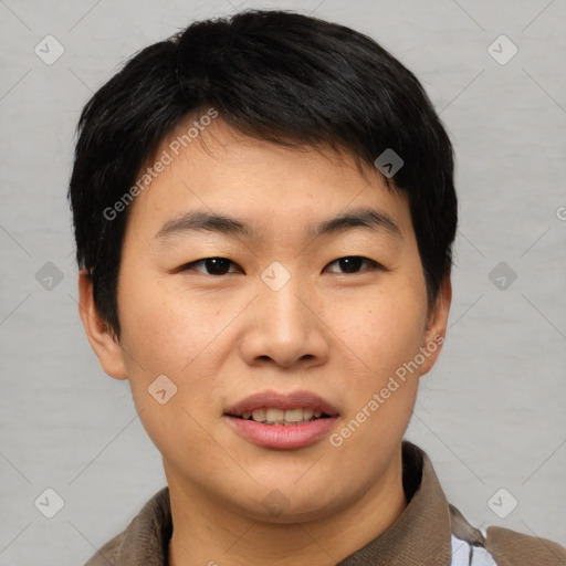 Joyful asian young-adult male with short  brown hair and brown eyes