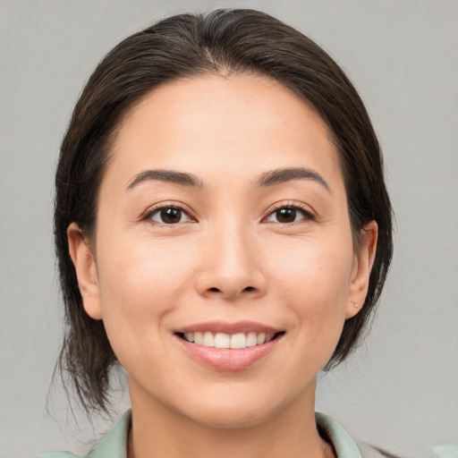 Joyful white young-adult female with medium  brown hair and brown eyes