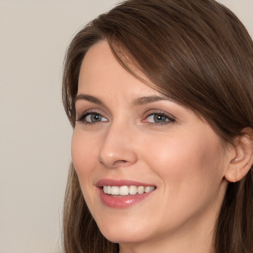 Joyful white young-adult female with long  brown hair and brown eyes