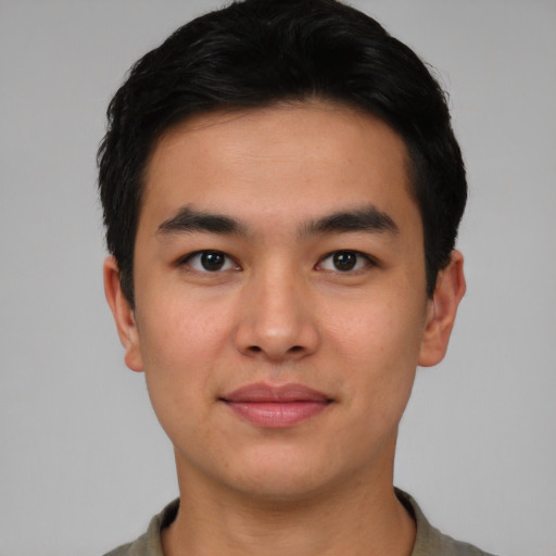 Joyful asian young-adult male with short  black hair and brown eyes