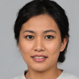 Joyful asian young-adult female with medium  brown hair and brown eyes